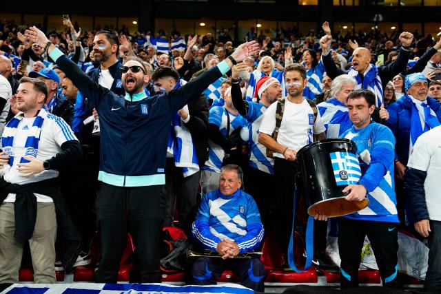 Greek fans cheer ahead the 2026 World Cup qualifiers Europe zone group G football match between Denmark and Greece on October 12, 2025 in Copenhagen.  (Photo by Mads Claus Rasmussen / Ritzau Scanpix / AFP) / Denmark OUT