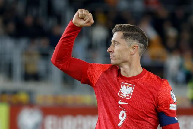Poland's forward #09 Robert Lewandowski celebrates scoring the 0-2 goal during the 2026 World Cup qualifiers Europe zone group G football match between Lithuania and Poland on October 12, 2025 in Kaunas, Lithuania.  (Photo by Petras Malukas / AFP)