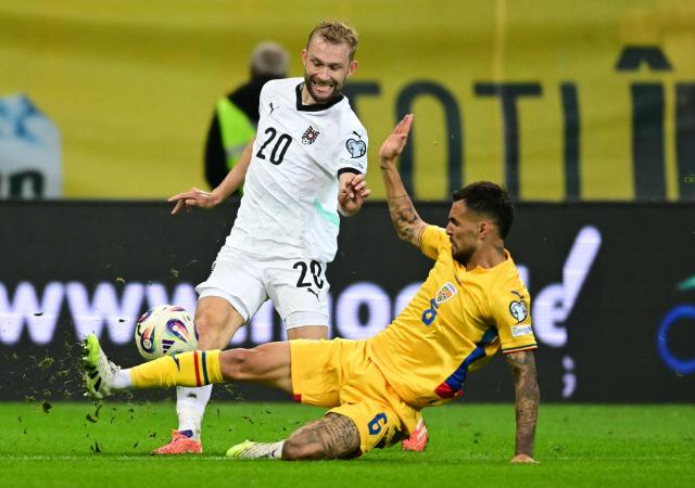 Austria's midfielder #20 Konrad Laimer (L) and Romania's midfielder #06 Marius Marin vie for the ball during the 2026 World Cup qualifiers Europe zone group H football match between Romania and Austria on October 12, 2025 in Bucharest, Romania. (Photo by Daniel MIHAILESCU / AFP)