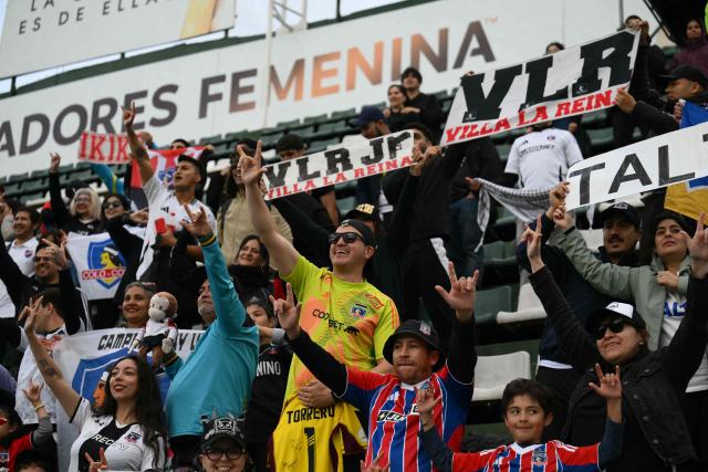 Fans of Colo Colo celebrate after their team won the 2025 Women's Copa Libertadores quarter-final football match between Chile's Colo Colo and Paraguay's Libertad at the Florencio Sola Stadium in Banfield, Buenos Aires province on October 12, 2025. (Photo by Luis ROBAYO / AFP)