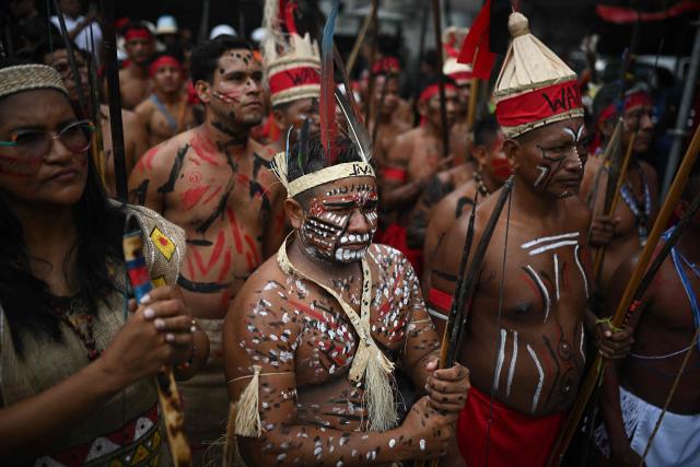 Venezuelan indigenous take part in a march to commemorate the "Day of Indigenous Resistance" in Caracas on October 12, 2025. On Sunday, Venezuelan President Nicolбs Maduro called opposition leader Marнa Corina Machado a “demonic witch,” two days after she was awarded the Nobel Peace Prize. (Photo by Federico PARRA / AFP)