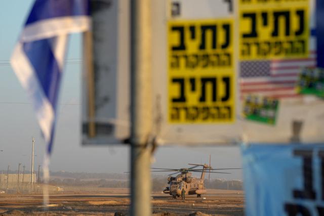 An Israeli military helicopter waits in preparation to take hostages released by Hamas in Gaza to hospitals in Israel after they arrive in the southern Reim army base on October 13, 2025. Hamas was set to release all surviving Israeli hostages on October 13 in exchange for Palestinian prisoners held by Israel, as US President Donald Trump headed to the region for a peace summit having declared the war "over". Trump's lightning visit to Israel and Egypt aims to celebrate his role in brokering last week's ceasefire and hostage release deal -- but comes at a precarious time as Israel and Hamas negotiate what comes next. (Photo by MAYA LEVIN / AFP)