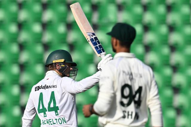 South Africa's Ryan Rickelton (L) celebrates after scoring half century (50 runs) during the second day of the first Test cricket match between Pakistan and South Africa at the Gaddafi Stadium in Lahore on October 13, 2025. (Photo by Aamir QURESHI / AFP)