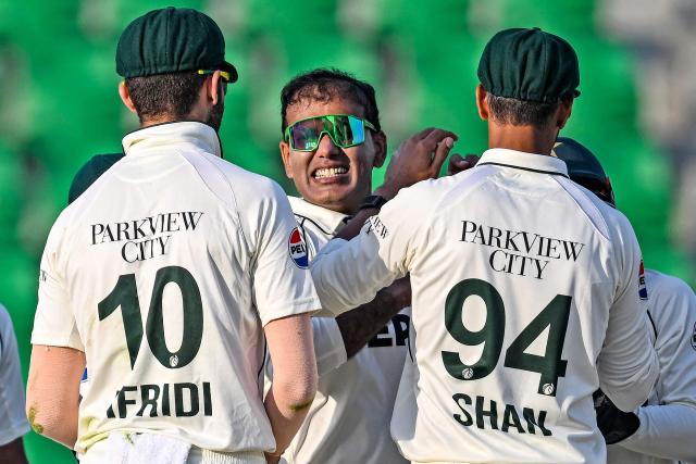 Pakistan's Noman Ali (C) celebrates with teammates after taking he wicket of South Africa's Tristan Stubbs during the second day of the first Test cricket match between Pakistan and South Africa at the Gaddafi Stadium in Lahore on October 13, 2025. (Photo by Aamir QURESHI / AFP)