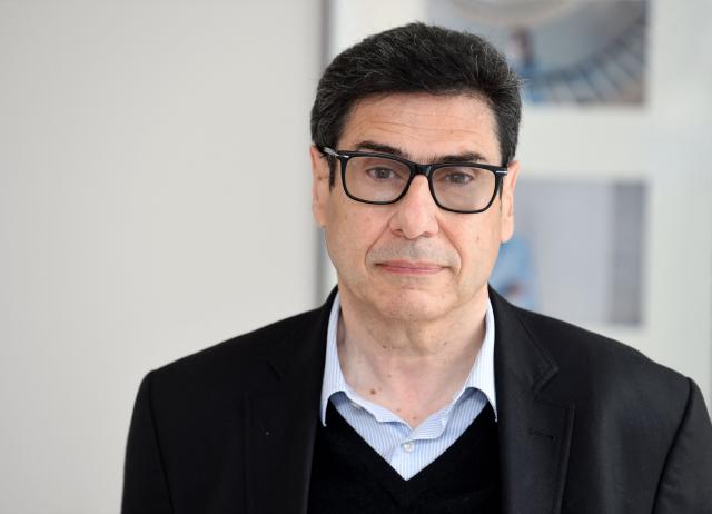 (FILES) French Economist Philippe Aghion poses at the College de France in Paris on June 08, 2021. The Royal Swedish Academy of Sciences has decided to award the Sveriges Riksbank Prize in Economic Sciences in Memory of Alfred Nobel 2025 to Joel Mokyr, Philippe Aghion and Peter Howitt "for having explained innovation-driven economic growth" with one half to Joel Mokyr "for having identified the prerequisites for sustained growth through technological progress" and the other half jointly to Philippe Aghion and Peter Howitt "for the theory of sustained growth through creative destruction." (Photo by Eric PIERMONT / AFP)