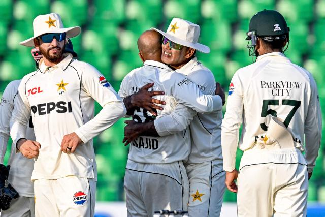 Pakistan's Sajid Khan (2L) celebrates with Noman Ali (2R) after taking the wicket of South Africa's Dewald Brevis during the second day of the first Test cricket match between Pakistan and South Africa at the Gaddafi Stadium in Lahore on October 13, 2025. (Photo by Aamir QURESHI / AFP)