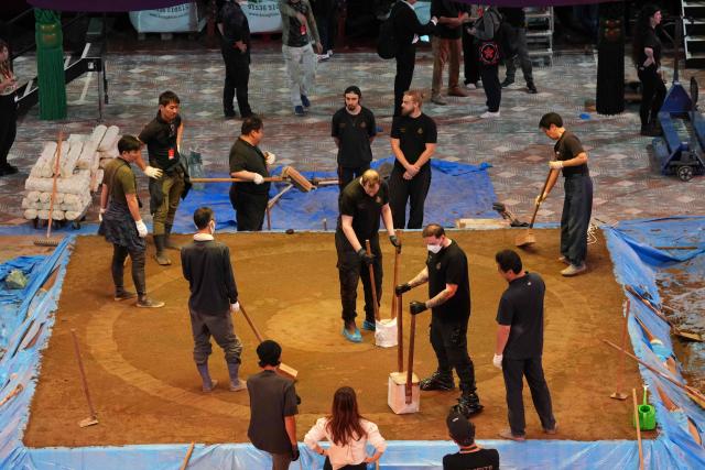 Members of the crew construct the dohyo, the ring, made from clay and sand, as preparations are underway inside the Royal Albert Hall in central London on October 13, 2025, ahead of the Grand Sumo Tournament being held over five days in London from October 15th. Over 40 of Japan’s elite maku-uchi rikishi (wrestlers) will compete in London this week, bringing with them the 1,500-year legacy of Sumo, 34 years after the venue last hosted the Tournament. (Photo by CARLOS JASSO / AFP)