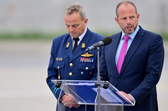 Belgium's Defence Minister Theo Francken (R), falnked by Belgian Air Force Commander Geert De Decker delivers his speech during the opening of the Complex F-35 ahead of the arrival of Lockheed Martin F-35 Lightning II fighter jets at the Florennes military airbase, southern Belgium on October 13, 2025. (Photo by DIRK WAEM / Belga / AFP) / Belgium OUT