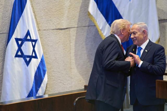 US President Donald Trump (L) speaks with Israel's Prime Minister Benjamin Netanyahu at the Israeli parliament, the Knesset, in Jerusalem on October 13, 2025. Hamas handed over the 20 surviving Israeli hostages on October 13 under a ceasefire agreement, as the US president and other world leaders geared up for a summit on Gaza. The releases are part of a ceasefire agreement brokered by the US president, with Israel due in return to free nearly 2,000 detainees held in its jails in exchange. (Photo by Evan Vucci / POOL / AFP)