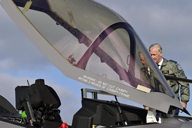 Belgium's King Philippe takes a look at a newly purchased Lockheed Martin F-35 Lightning II fighter jet after arriving at the Florennes military airbase, southern Belgium on October 13, 2025. (Photo by DIRK WAEM / Belga / AFP) / Belgium OUT