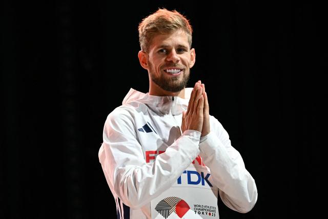 (FILES) Bronze medallist France's Jimmy Gressier celebrates on the podium of the men's 5000m final during the World Athletics Championships in Tokyo on September 21, 2025. France's Jimmy Gressier, who was crowned world champion in the 10,000 metres in Tokyo at the end of September 2025, is among the nominees for the title of best track athlete of the year, according to the list unveiled on October 13, 2025 by World Athletics. (Photo by Philip FONG / AFP)