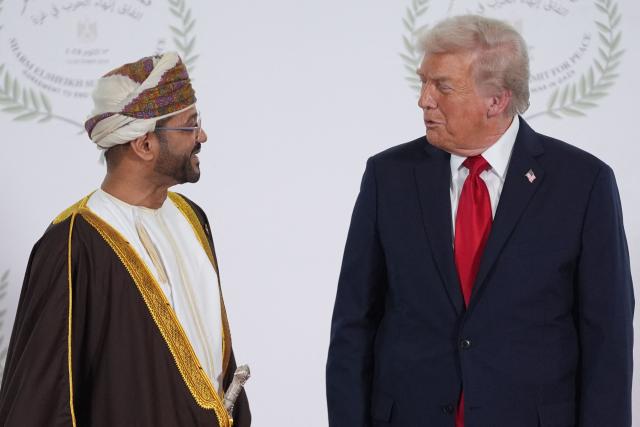 US President Donald Trump greets Oman's Foreign Minister Sayyid Badr bin Hamad Albusaidi during a summit on Gaza in Sharm el-Sheikh on October 13, 2025. Trump landed in Egypt on October 13 for a summit on Gaza, following a lightning visit to Israel after a ceasefire he brokered entered into force. (Photo by Evan Vucci / POOL / AFP)