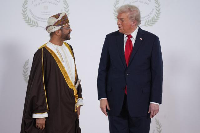 US President Donald Trump greets Oman's Foreign Minister Sayyid Badr bin Hamad Albusaidi during a summit on Gaza in Sharm el-Sheikh on October 13, 2025. Trump landed in Egypt on October 13 for a summit on Gaza, following a lightning visit to Israel after a ceasefire he brokered entered into force. (Photo by Evan Vucci / POOL / AFP)