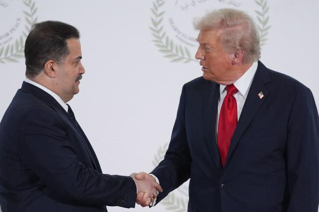US President Donald Trump greets Iraq's Prime Minister Mohammed Shia al-Sudani during a summit on Gaza in Sharm el-Sheikh on October 13, 2025. Trump landed in Egypt on October 13 for a summit on Gaza, following a lightning visit to Israel after a ceasefire he brokered entered into force. (Photo by Evan Vucci / POOL / AFP)