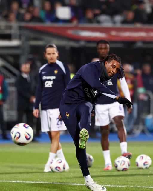 France's midfielder #11 Michael Olise kicks the ball as he warms up prior to the 2026 World Cup qualifying round Group D football match between Iceland and France at the Laugardalsvollur Stadium in Reykjavik on October 13, 2025. (Photo by FRANCK FIFE / AFP)