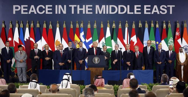 TOPSHOT - US President Donald Trump (C) delivers a statement during a summit on Gaza in Sharm el-Sheikh on October 13, 2025. US President Donald Trump hailed a "tremendous day for the Middle East" as he and regional leaders signed a declaration on October 13, 2025 meant to cement a ceasefire in Gaza, hours after Israel and Hamas exchanged hostages and prisoners. (Photo by Yoan VALAT / POOL / AFP)