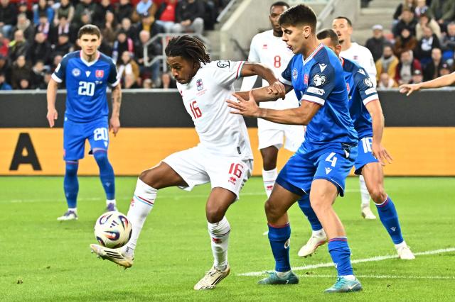 Luxembourg's midfielder #16 Leandro Barreiro (L) and Slovakia's defender #04 Adam Obert vie for the ball during the 2026 World Cup qualifying group A football match between Slovakia and Luxembourg in Trnava, Slovakia on October 13, 2025, (Photo by Joe Klamar / AFP)
