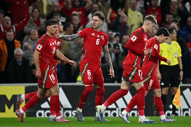 Wales' defender Joe Rodon (C) celebrates scoring the team's first goal during the 2026 World Cup Group J qualifier football match between Wales and Belgium, at Cardiff City Stadium, in Cardiff, on October 13, 2025. (Photo by Paul ELLIS / AFP)