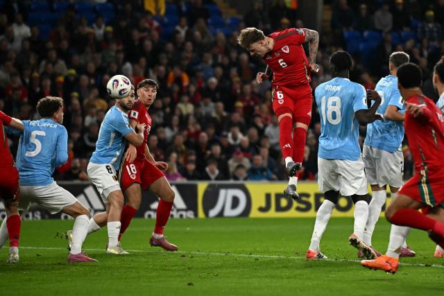 Wales' defender Joe Rodon scores the team's first goal during the 2026 World Cup Group J qualifier football match between Wales and Belgium, at Cardiff City Stadium, in Cardiff, on October 13, 2025. (Photo by Paul ELLIS / AFP)