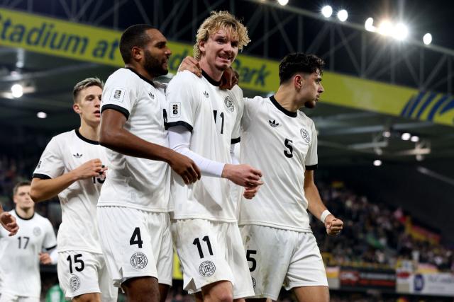 Germany's striker #11 Nick Woltemade (C) celebrates scoring the team's first goal during the 2026 World Cup Group A qualifying football match between Northern Ireland and Germany at Windsor Park stadium, in Belfast, on October 13, 2025. (Photo by Paul Faith / AFP)