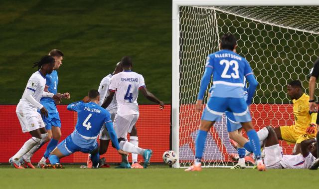 Iceland's defender #04 Victor Palsson (3L) scores his team's first goal past France's goalkeeper #16 Mike Maignan during the 2026 World Cup qualifying round Group D football match between Iceland and France at the Laugardalsvollur Stadium in Reykjavik on October 13, 2025. (Photo by FRANCK FIFE / AFP)