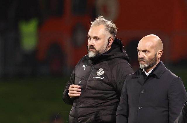 Iceland's head coach Arnar Gunnlaugsson (R) and Iceland's assistant coach David Snorri Jonasson look on during the 2026 World Cup qualifying round Group D football match between Iceland and France at the Laugardalsvollur Stadium in Reykjavik on October 13, 2025. (Photo by FRANCK FIFE / AFP)