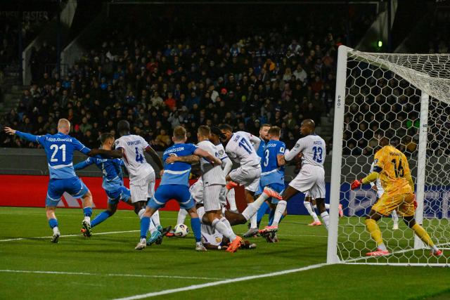Iceland's defender #04 Victor Palsson (2nd L) scores the opening goal past France's goalkeeper #16 Mike Maignan (R) during the 2026 World Cup qualifying round Group D football match between Iceland and France at the Laugardalsvollur Stadium in Reykjavik on October 13, 2025. (Photo by Halldor KOLBEINS / AFP)