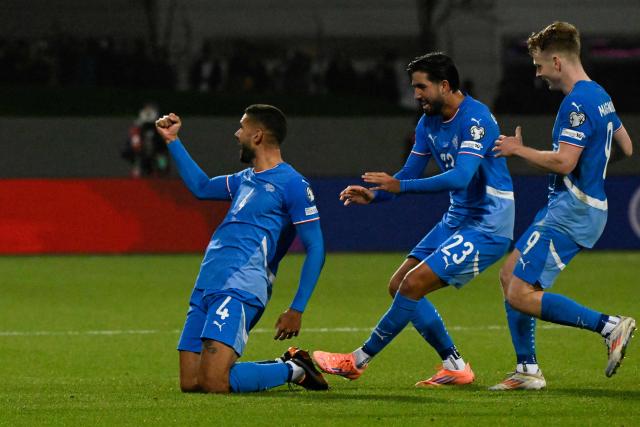 Iceland's defender #04 Victor Palsson (L) celebrates scoring the opening goal with his teammates Iceland's forward #23 Mikael Egill Ellertsson and Iceland's midfielder #09 Saevar Atli Magnusson during the 2026 World Cup qualifying round Group D football match between Iceland and France at the Laugardalsvollur Stadium in Reykjavik on October 13, 2025. (Photo by Halldor KOLBEINS / AFP)