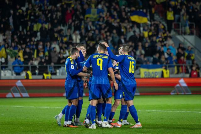 Ukraine's midfielder #09 Oleksii Hutsuliak (C) celebrates scoring the opening goal with his teammates during the 2026 World Cup qualifying group B, football match between Ukraine and Azerbaijan in Krakow, Poland, on October 13, 2025, (Photo by Wojtek RADWANSKI / AFP)