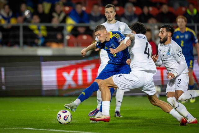 Ukraine's forward #11 Artem Dovbyk (L) and Azerbaijan's defender #04 Bahlul Mustafazade (C) vie for the ball during the 2026 World Cup qualifying group B, football match between Ukraine and Azerbaijan in Krakow, Poland, on October 13, 2025, (Photo by Wojtek RADWANSKI / AFP)