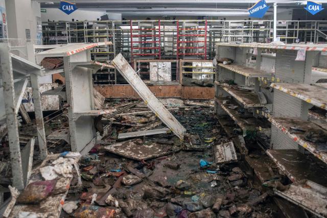 View of the rubble of a looted store after severe flooding hit the city of Alamo, in Veracruz state, Mexico, on October 13, 2025. The death toll from flooding in central and eastern Mexico -mostly in the Veracruz, Hidalgo and Puebla states- has risen sharply to at least 64, with another 65 still missing, authorities reported. (Photo by Hector  Quintanar / AFP)