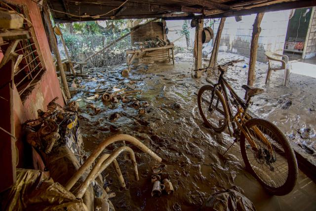 View of the debris of a damaged house after severe flooding hit the city of Alamo, in Veracruz state, Mexico, on October 13, 2025. The death toll from flooding in central and eastern Mexico -mostly in the Veracruz, Hidalgo and Puebla states- has risen sharply to at least 64, with another 65 still missing, authorities reported. (Photo by Marco Antonio Perez / AFP)
