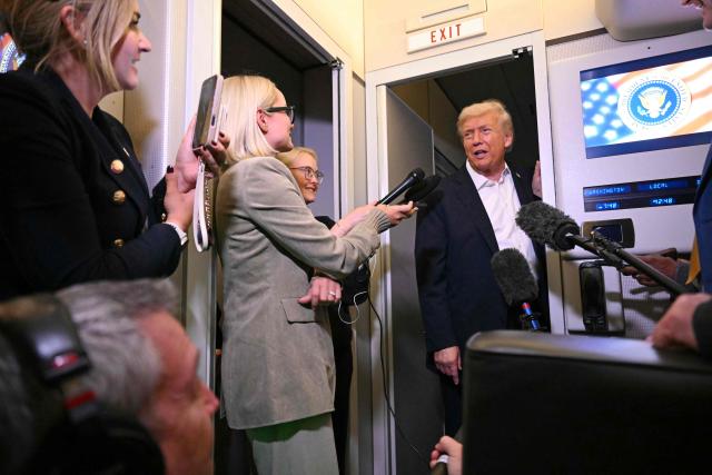 US President Donald Trump speaks with the press on board Air Force One in Mildenhall, Suffolk on October 14, 2025. US President Donald Trump hailed a "tremendous day for the Middle East" as he and regional leaders signed a declaration  meant to cement a ceasefire in Gaza, hours after Israel and Hamas exchanged hostages and prisoners. (Photo by SAUL LOEB / AFP)