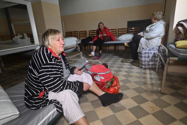 Hospital patients sit in a bomb shelter under one of the hospital buildings following Russian strikes in Kharkiv, on October 13, 2025, amid the Russian invasion of Ukraine. (Photo by SERGEY BOBOK / AFP)