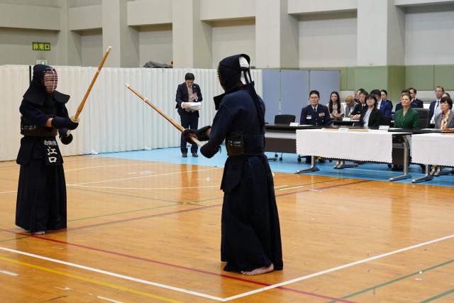 Crown Princess Victoria of Sweden (2nd R, in green) attends a martial arts demonstration as she visits the Joint Staff College, an educational institution administered by the Ministry of Defence's Joint Staff Office, in Tokyo on October 14, 2025. (Photo by Kazuhiro NOGI / AFP)