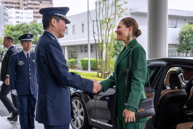 Crown Princess Victoria of Sweden (R) is welcomed by Lt Gen Amio Sato, Commandant of Joint staff College, an educational institution administered by the Ministry of Defence's Joint Staff Office, during her arrival at the college in Tokyo on October 14, 2025. (Photo by Kazuhiro NOGI / AFP)