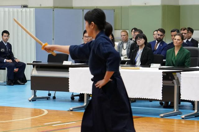 Crown Princess Victoria of Sweden (R) attends a martial arts demonstration as she visits the Joint Staff College, an educational institution administered by the Ministry of Defence's Joint Staff Office, in Tokyo on October 14, 2025. (Photo by Kazuhiro NOGI / AFP)