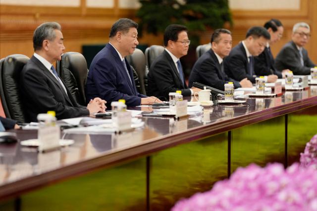 Chinese President Xi Jinping (2nd L) speaks during a meeting with Dominica’s President Sylvanie Burton (not pictured) at the Great Hall of the People in Beijing on October 14, 2025. (Photo by Ichiro Banno / POOL / AFP)