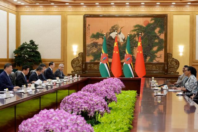 China's President Xi Jinping (L) and Dominica's President Sylvanie Burton (R) attend a meeting at the Great Hall of the People in Beijing on October 14, 2025. (Photo by Ichiro Banno / POOL / AFP)