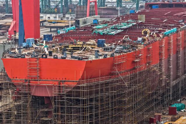 This aerial view shows a ship under construction at a shipbuilding facility along the Yangtze River in Yangzhou, east China's Jiangsu province, on October 14, 2025. (Photo by -STR / AFP) / China OUT