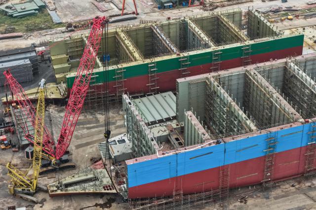 This aerial view shows ships under construction at a shipbuilding facility along the Yangtze River in Yangzhou, east China's Jiangsu province, on October 14, 2025. (Photo by -STR / AFP) / China OUT