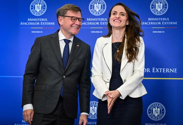 Romanian Foreign Minister Oana Toiu (R) and German Foreign Minister Johann Wadephul share a smile as they meet at the Romanian Foreign Office in Bucharest, Romania, on October 14, 2025. (Photo by Daniel MIHAILESCU / AFP)