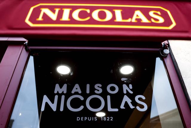 This photograph shows the newly rebranded signage "La Maison Nicolas" of French liquor and spirits chain retail shop Nicolas, in Paris on October 13, 2025. (Photo by Ian LANGSDON / AFP)