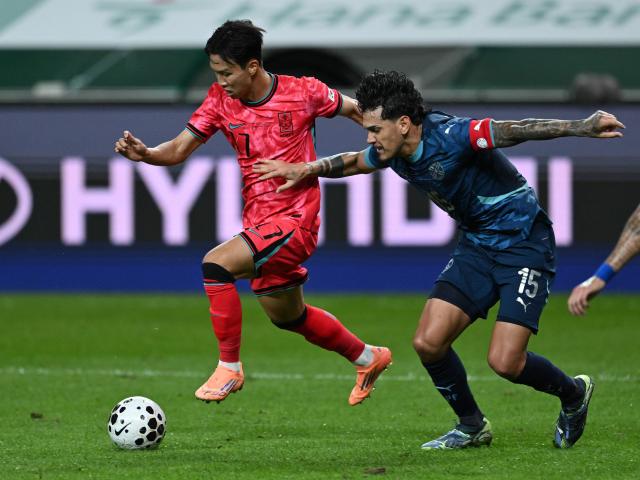 South Korea's Eom Ji-sung (L) fights for the ball with Paraguay's Gustavo Gomez (R) during a friendly football match between South Korea and Paraguay in Seoul on October 14, 2025. (Photo by Jung Yeon-je / AFP)