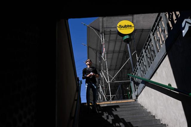 A commuter enters a subway station in Buenos Aires on October 14, 2025. Argentina's statistics agency INDEC is expected to announce September’s inflation rate later in the day. (Photo by Luis ROBAYO / AFP)