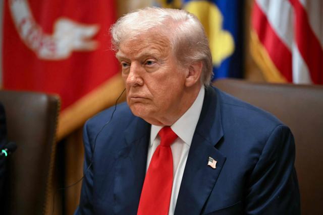 US President Donald Trump looks on as Argentina's President Javier Milei (not pictured) speaks in the Cabinet Room at the White House in Washington, DC on October 14, 2025. (Photo by ANDREW CABALLERO-REYNOLDS / AFP)