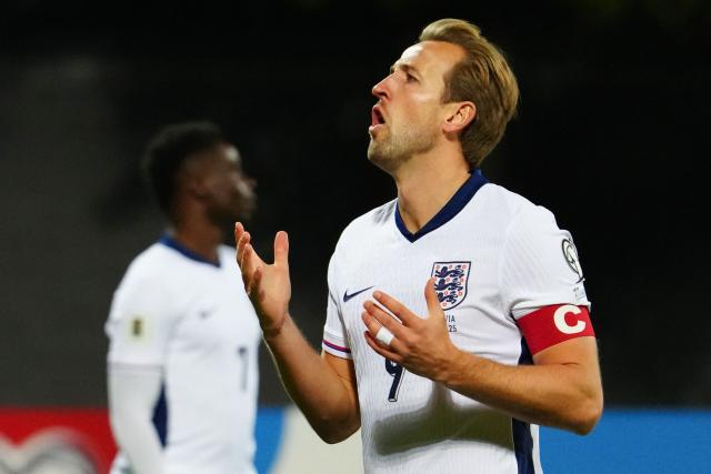 England's forward #09 Harry Kane (L) reacts after failing to score during the 2026 World Cup qualifying group K football match between Latvia and England at the Daugava Stadium in Riga, Latvia on October 14, 2025, (Photo by Gints Ivuskans / AFP)