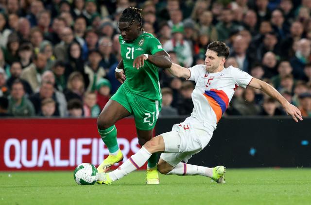 Republic of Ireland's defender #21 Festy Ebosele is tackled by Armenia's defender #05 Styopa Mkrtchyan during the 2026 World Cup Group F qualifier football match between Republic of Ireland and Armenia, at Aviva Stadium, in Dublin, on October 14, 2025. (Photo by Paul Faith / AFP)
