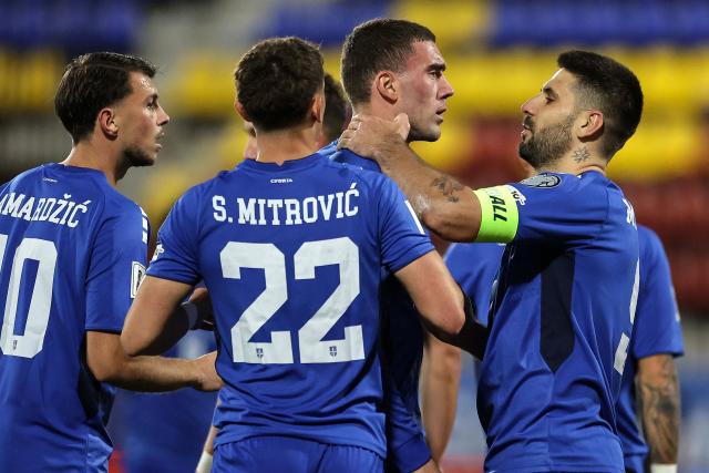 Serbia's forward #23 Dusan Vlahovic (2R) celebrates with teammates after scoring Serbia's second goal during the FIFA World Cup 2026 Group K European qualification football match between Andorra and Serbia, at the New FAF Stadium in Encamp, on October 14, 2025. (Photo by Valentine CHAPUIS / AFP)