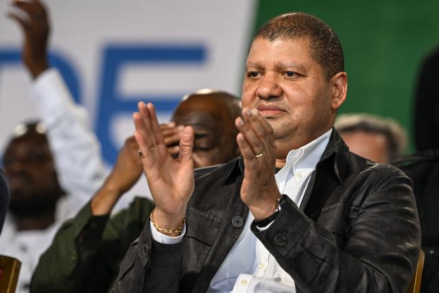Presidential candidate for the Democratic Congress (CODE) Jean-Louis Billon applauds during a campaign Rally in the commune of Cocody in Abidjan on October 14, 2025. Ivory Coast Presidential election is scheduled for October 25, 2025. (Photo by Sia KAMBOU / AFP)